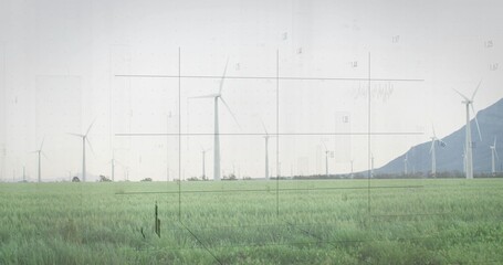 Featuring wind turbine spinning above grassland at wind farm, with mountain ridge, grid overlay