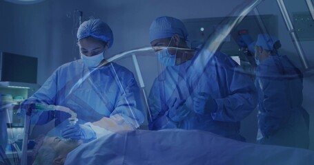 Adjusting mask and tube as surgeon holding tool above patient in OR, with vitals monitor