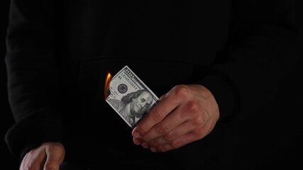 Man burning dollar banknotes on black background, closeup - Powered by Adobe