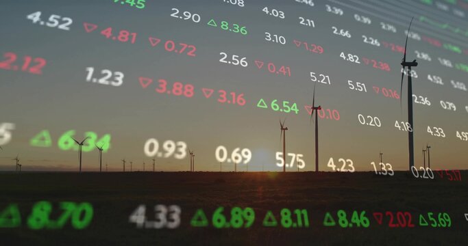 Showing silhouette wind turbines on flat farmland at dusk, with red and green market data overlay