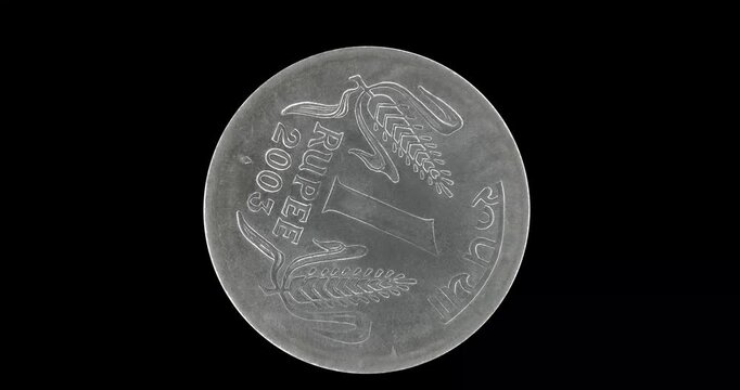 Reverse of India coin 1 rupee 2003, isolated in black background. Loopable animation in 4k resolution video