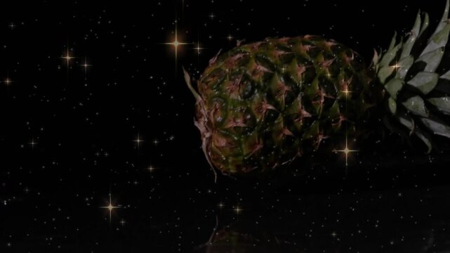 Upon crown tip entering frame, pineapple drifting leftward and rotating, revealing textured skin