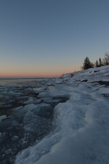 Chunks of ice frozen along Lake Superior’s shore during the blue hour.