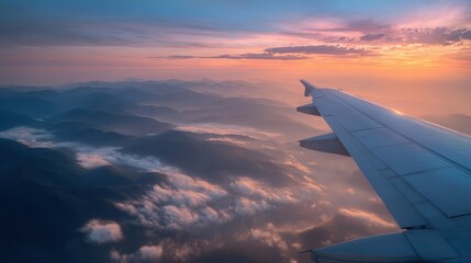 Stunning photo of view from airplane window during sunset over mountains and clouds.