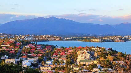 A mountainous backdrop, underlining a blend of urban and natural landscapes in Noumea, New Caledonia.