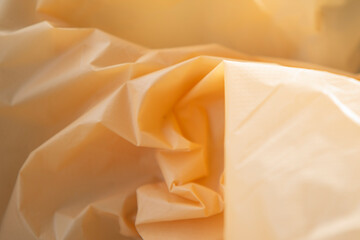 Obraz premium Crumpled plastic bag as background, closeup. Yellow texture