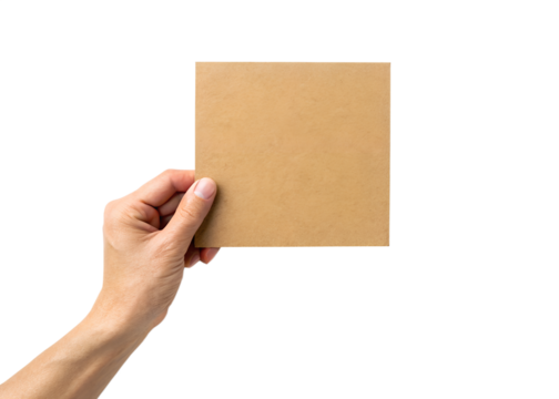 Hand holding a blank brown cardboard square card against a solid black background for copy space