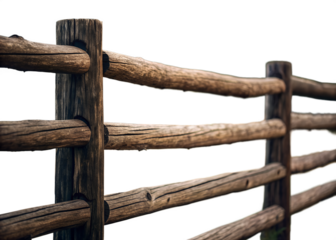 Rustic wooden split rail fence with weathered texture and natural imperfections against a dark background