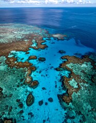 Obraz premium Aerial view of a coral reef system with vibrant turquoise water and deep blue sea