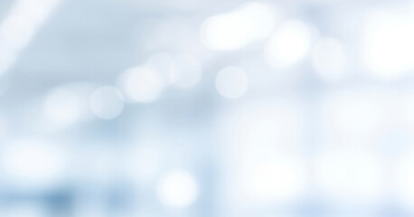 Abstract DSLR blurred business background in shades of white and light blue with subtle bokeh, creating a calm bright and professional atmosphere.