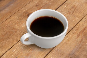 cup of tasty hot americano coffee on desk