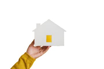 hand holding a small house on white background