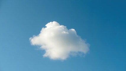 A solitary white cloud drifting across a clear blue sky, embodying simplicity and peace.