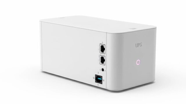A white rectangular device with ports on one side, a glowing light indicator, and the letters "UPS". It is isolated against a white background