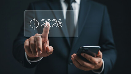 Businessman touching digital target focusing on 2026 vision, futuristic business strategy concept