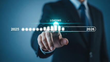 Businessman touching digital progress bar loading from 2025 to 2026 showing future growth concept