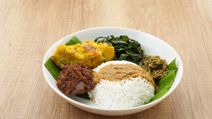 Nasi Padang or Nasi Kapau, rice with various side dishes rendang, egg, and sambal. Indonesian Food