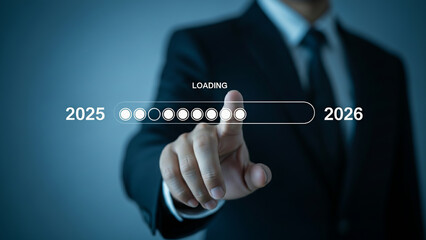 Businessman touching digital loading bar from 2025 to 2026 innovation progress and future growth concept