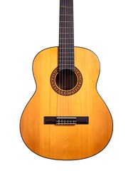 Obraz premium A wooden acoustic guitar in studio lighting, fully front-facing