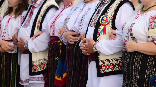 Dancers in traditional Moldavian and Romanian attire perform lively folk dances, displaying colorful costumes