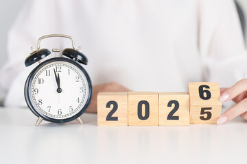 2025 end year to Happy New Year 2026 with vintage alarm clock. Christmas, New Start, Resolution, countdown, Goals, Plan, Action and Motivation Concept