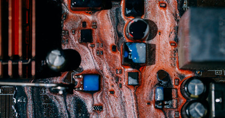 Paint drip. Electronic abstraction. Defocused orange blue colorful digital technology dark black glitter microchip water texture on art background.