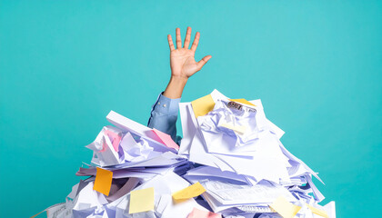 Overwhelmed by Paperwork: An arm emerges from a mountain of paper, symbolizing the feeling of being consumed by a workload, work-life balance