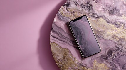 Smartphone on a pink marble plate with a pink background behind it