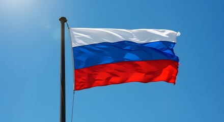 A tricolor flag of white, blue, and red waves in the wind against a clear blue sky
