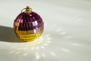 Shiny Disco Ball Ornament with Mirrored Tiles on White Surface. Celebration Concept for Christmas.