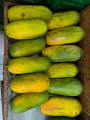 California papaya fruit in wooden boxes for sale at the fruit market.