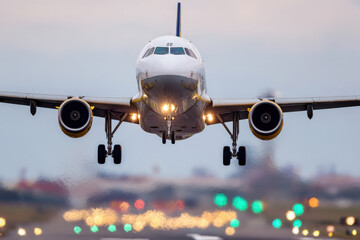 Naklejka premium Passenger plane landing at busy international airport