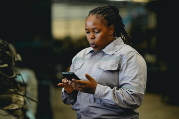 Female technician check used car damaged engine block at scrapyard warehouse recycle area part....