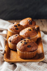 Delicious Chocolate Chip Muffins on a Wooden Tray with Napkin