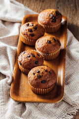 Freshly Baked Chocolate Chip Muffins on Wooden Tray
