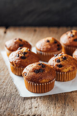 Freshly Baked Muffins with Chocolate Chips on Wooden Table