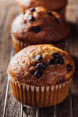 Freshly Baked Chocolate Chip Muffin on Rustic Wooden Table