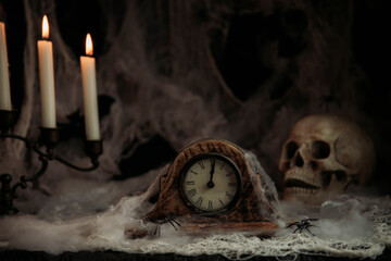Halloween composition with vintage clock and skull on black grunge background
