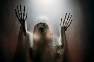 Mysterious creature with skull under the night light for Halloween