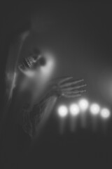 Mysterious creature with skull under the night light for Halloween