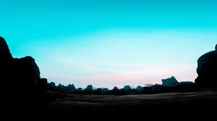 Natural rugged rock formation landscape with uneven terrain, brownish ground, clear blue sky gradient, soft lighting,