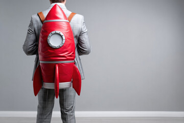 A businessman with rocket backpack, concept of startup growth