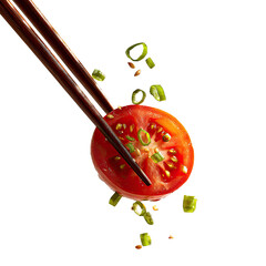Chopsticks poised over a tomato slice, with flying ingredients