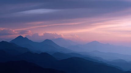 Obraz premium A majestic mountain range with peaks that float like islands in the sky during sunset.