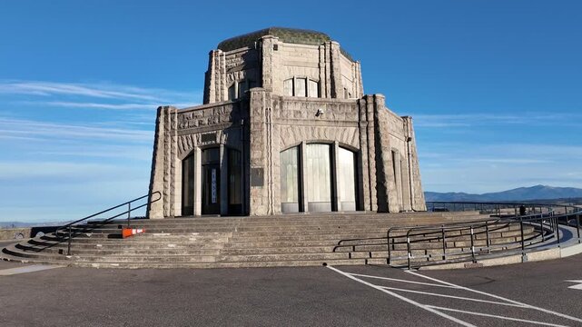 4K footage of Vista House at Crown Point in Columbia River Gorge, Oregon, USA. Historic stone building on a scenic viewpoint with clear sky, visited by travelers exploring this famous tour destination