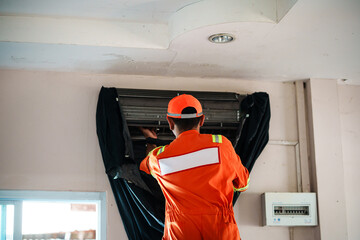 Air conditioner maintenance action by technician in residential space repair process indoor environment upward viewpoint