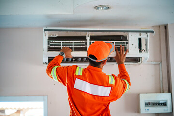 Air conditioning maintenance action indoor office technician working urban setting close-up view efficiency improvement