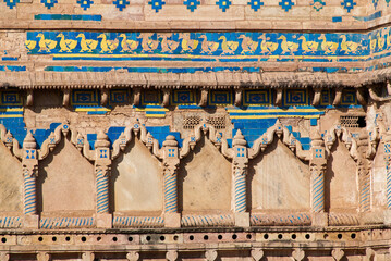 Ancient weathered wall at Gwalior fort with glazed tiles and duck motif. Gwalior Qila, Madhya Pradesh, India.