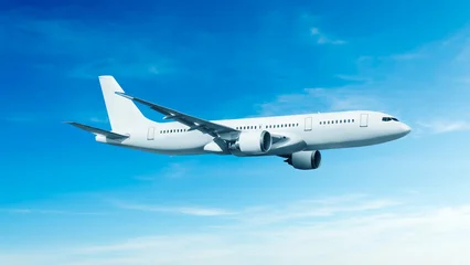 White airplane side view flying in the blue sky background. Modern passenger jet airplane. © Aryanto