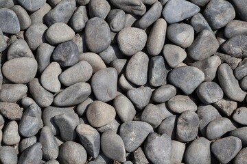 Small and medium sized gray natural stones, generally used for garden decoration. Natural stone texture and background for graphic design